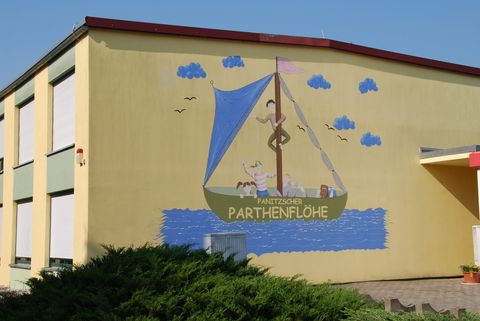 Unser Kitagebäude mit dem Logo der Parthenflöhe